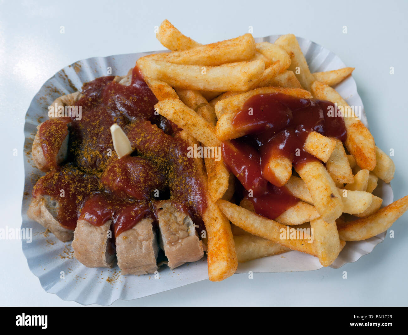 Detail of traditional Berlin currywurst snack at famous Konnopke`s curry-wurst stall in Prenzlauer Berg in Berlin Germany Stock Photo